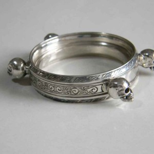 Custom hand engraved silver watch case with skulls